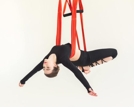 woman-practicing-fly-yoga-over-white-background-FR2QM6N.jpg